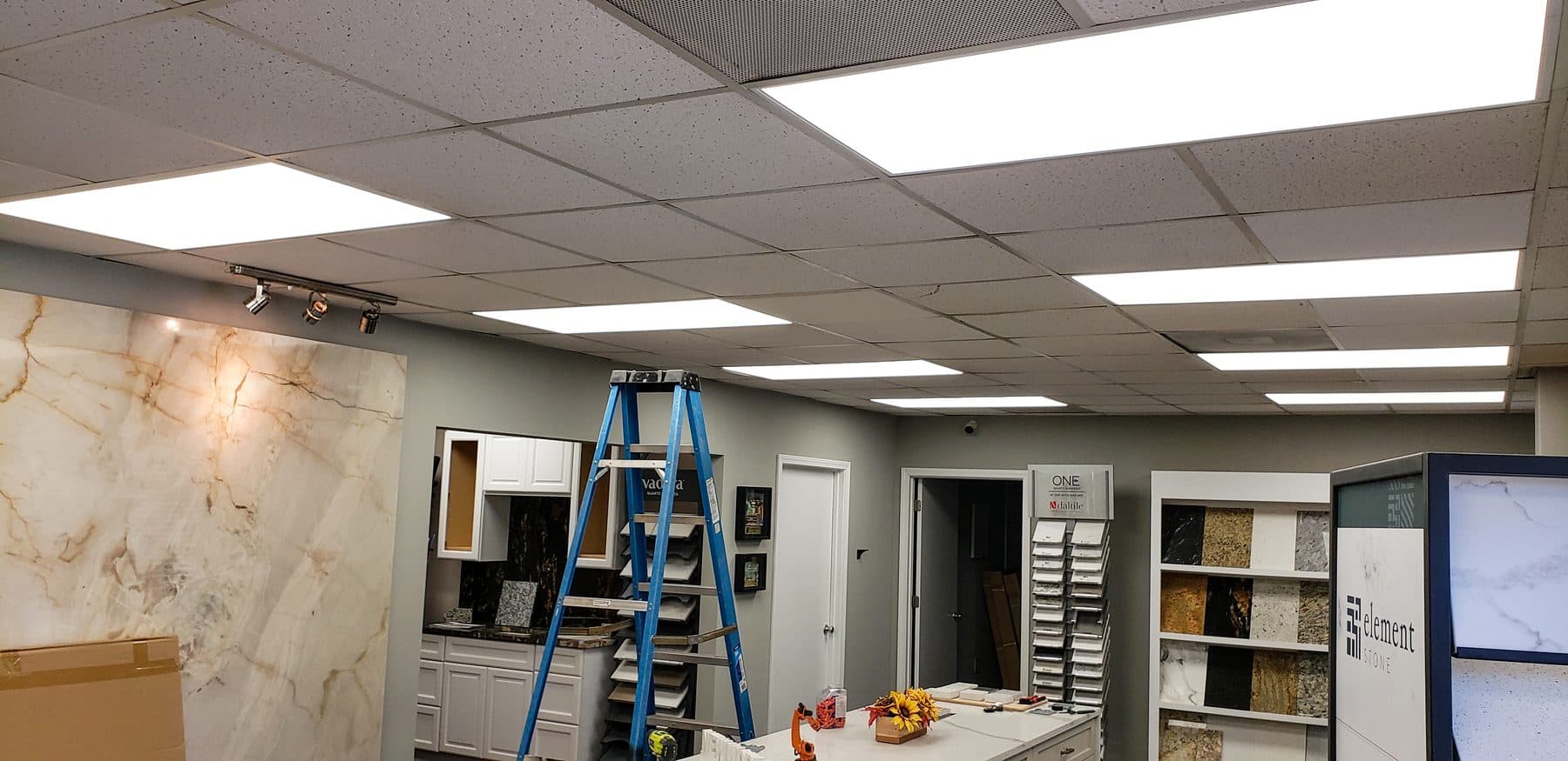 Showroom drop ceiling with LED panels over stone displays